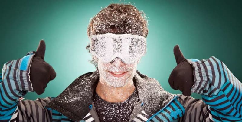 man with snow on his face head and neck