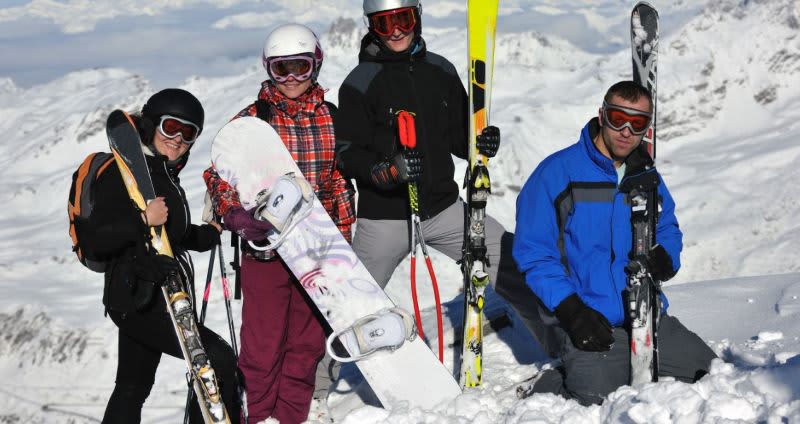 people with skis and snowboards