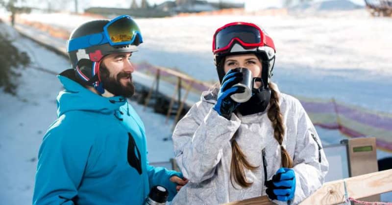 snowboarder and skier drinking snowboarder and skier drinking
