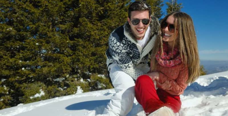 happy couple on a snowy ski mountain