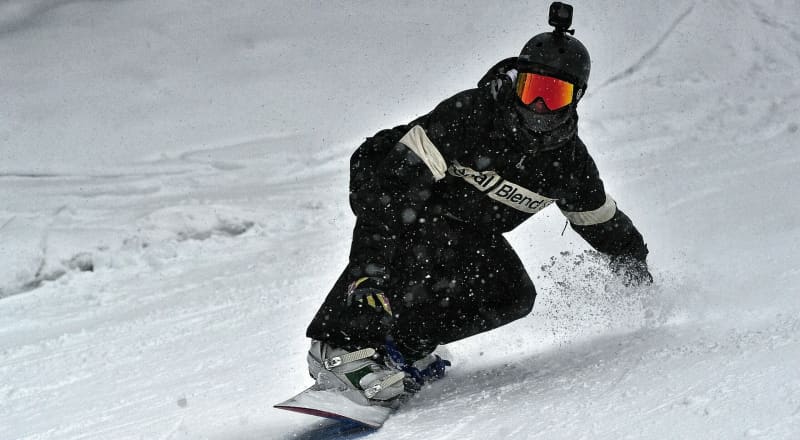 snowboarder wearing a neck gaiter over mouth and neck during winter snowboarder wearing a neck gaiter over mouth and neck during winter