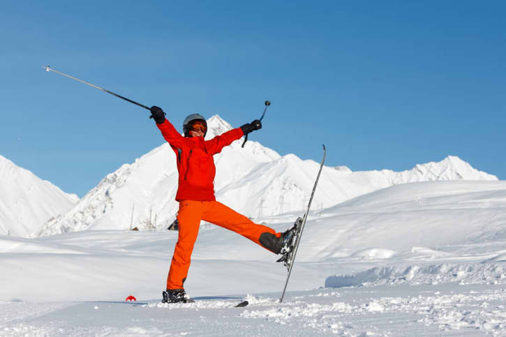 Happy orange skier