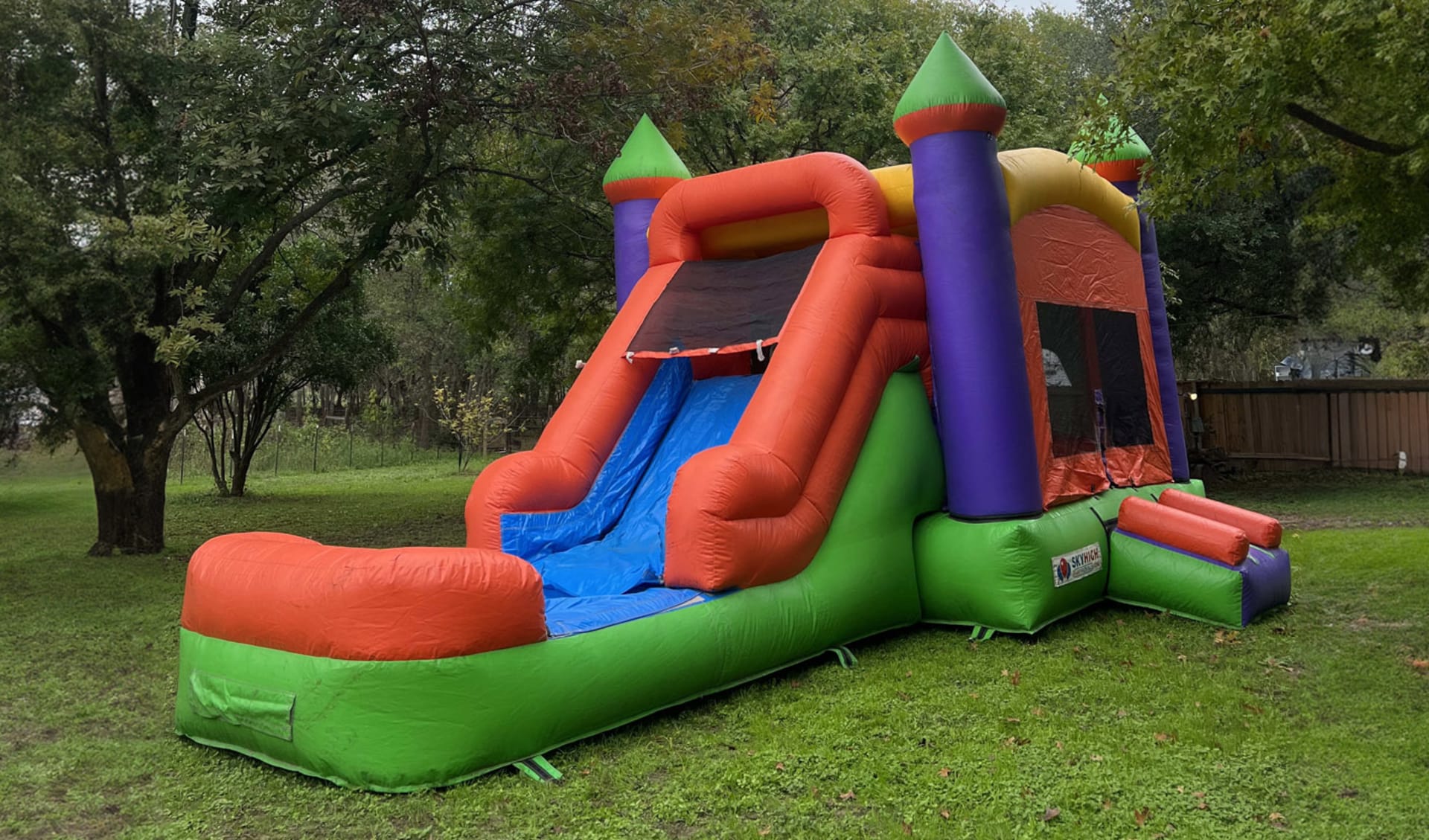 3-in-1 multi-color bounce house with water slide rental in Houston — perfect for The Woodlands backyard parties