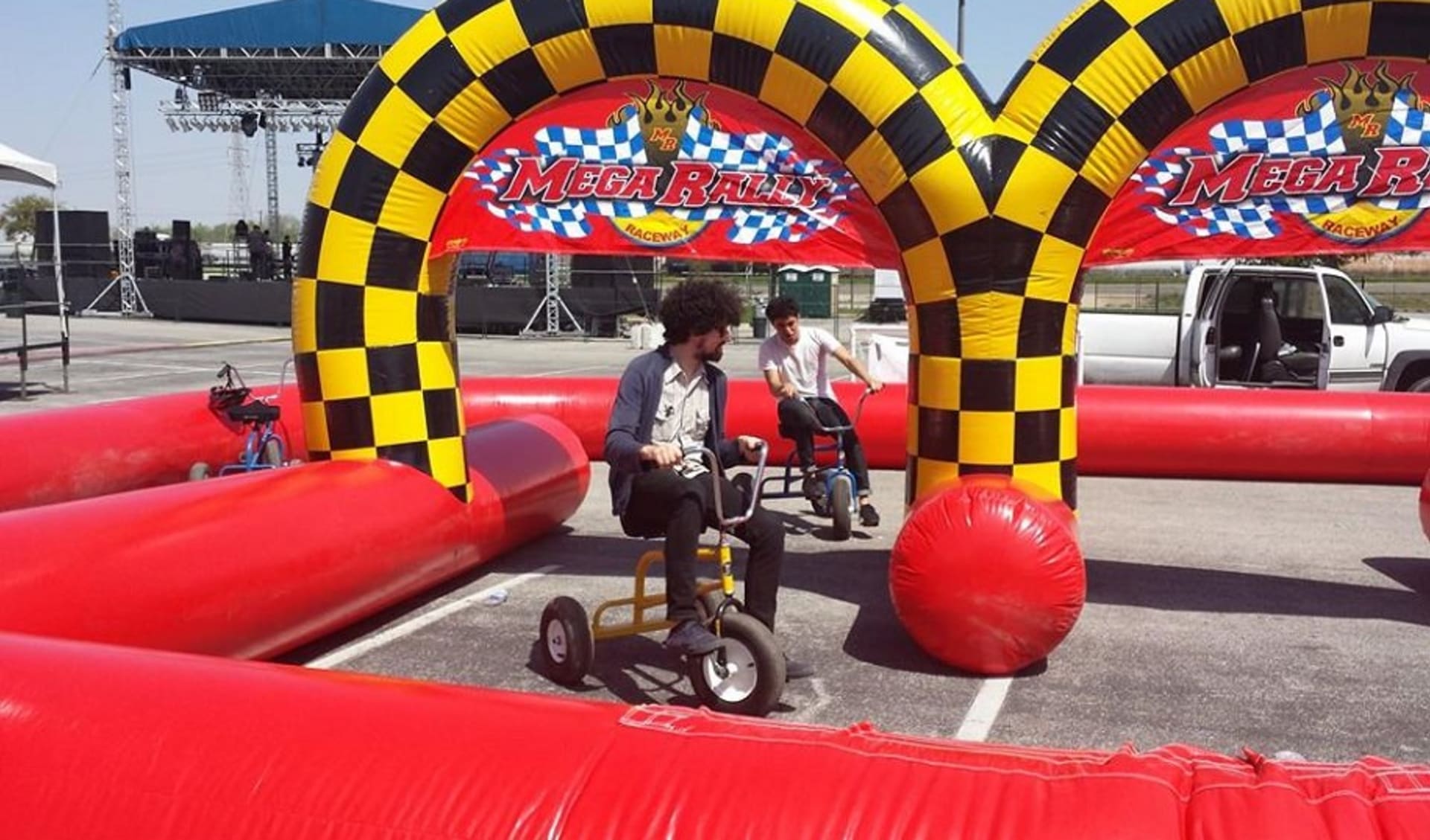 Red obstacle race track game rental with bold yellow checkered details, ideal for Plano celebrations.