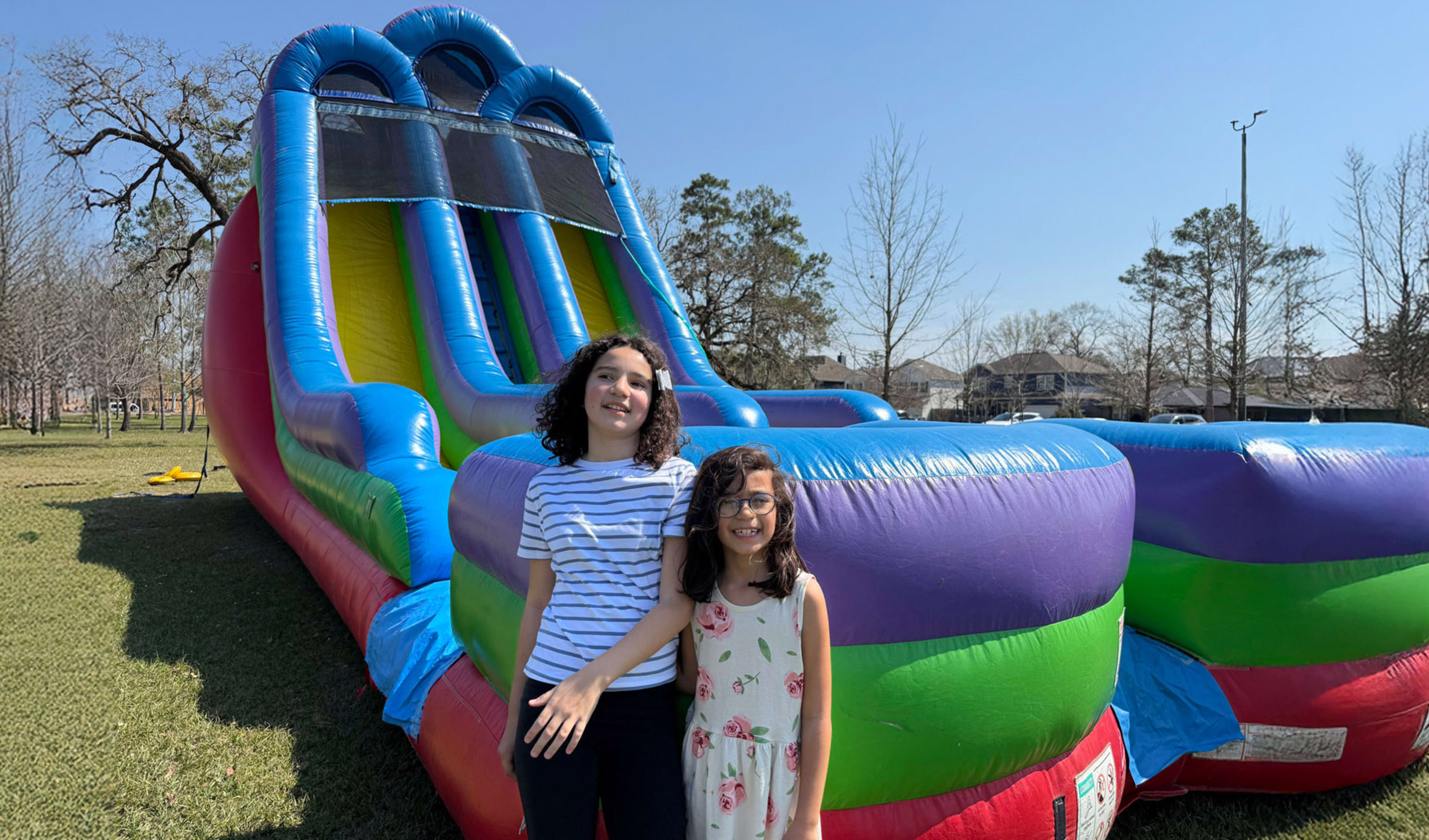 Kids in front playing on 18ft Retro Double Water Slide