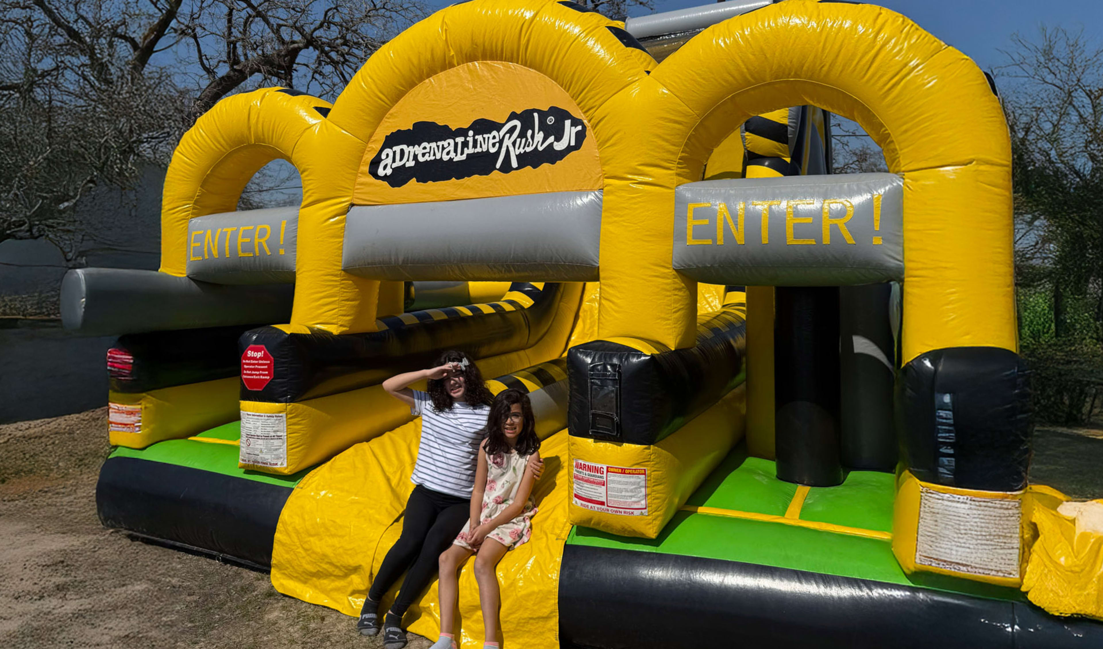 Kids in front Adrenaline toxic Obstacle Course Bounce house