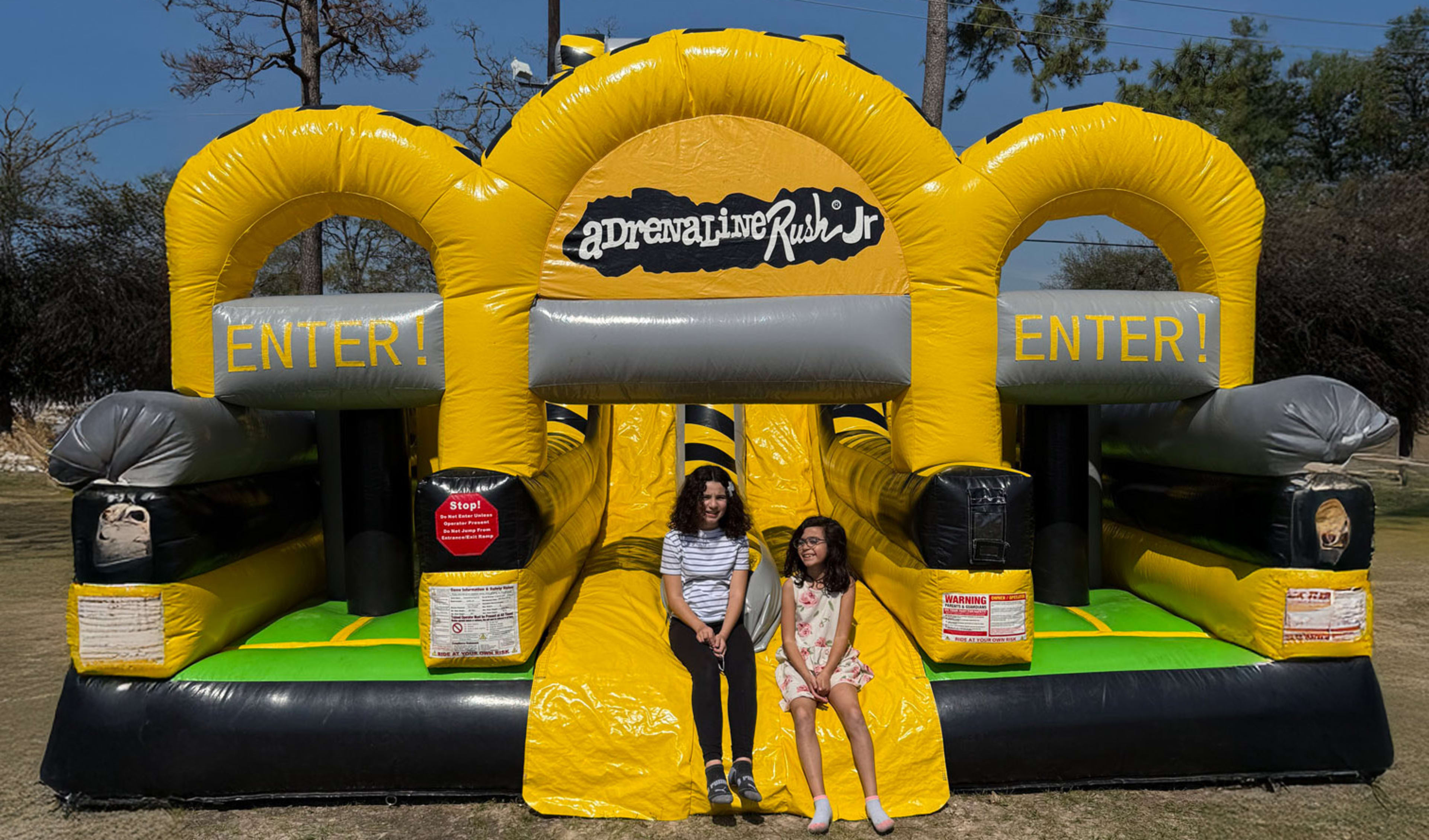Children in front of Adrenaline toxic Obstacle Course Bounce house