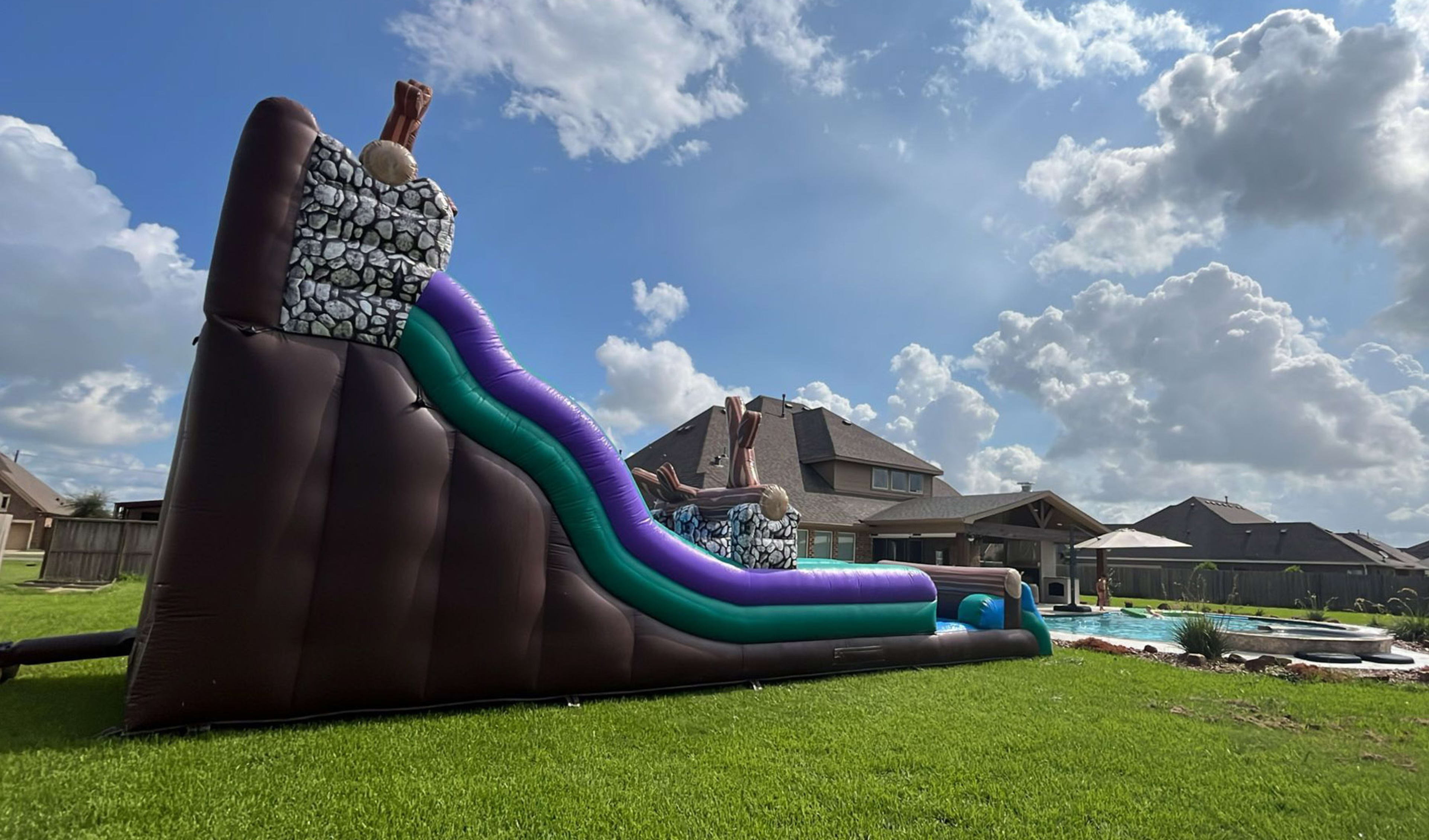 Backyard Water Slide for Rent next to a pool