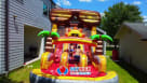 "Sunny Shades" double-lane inflatable water slide with a splash pool at a backyard birthday party in Houston. The slide features giant sunglasses and palm tree decor, with children sliding and playing with beach balls while adults supervise. Premium summe Youtube
