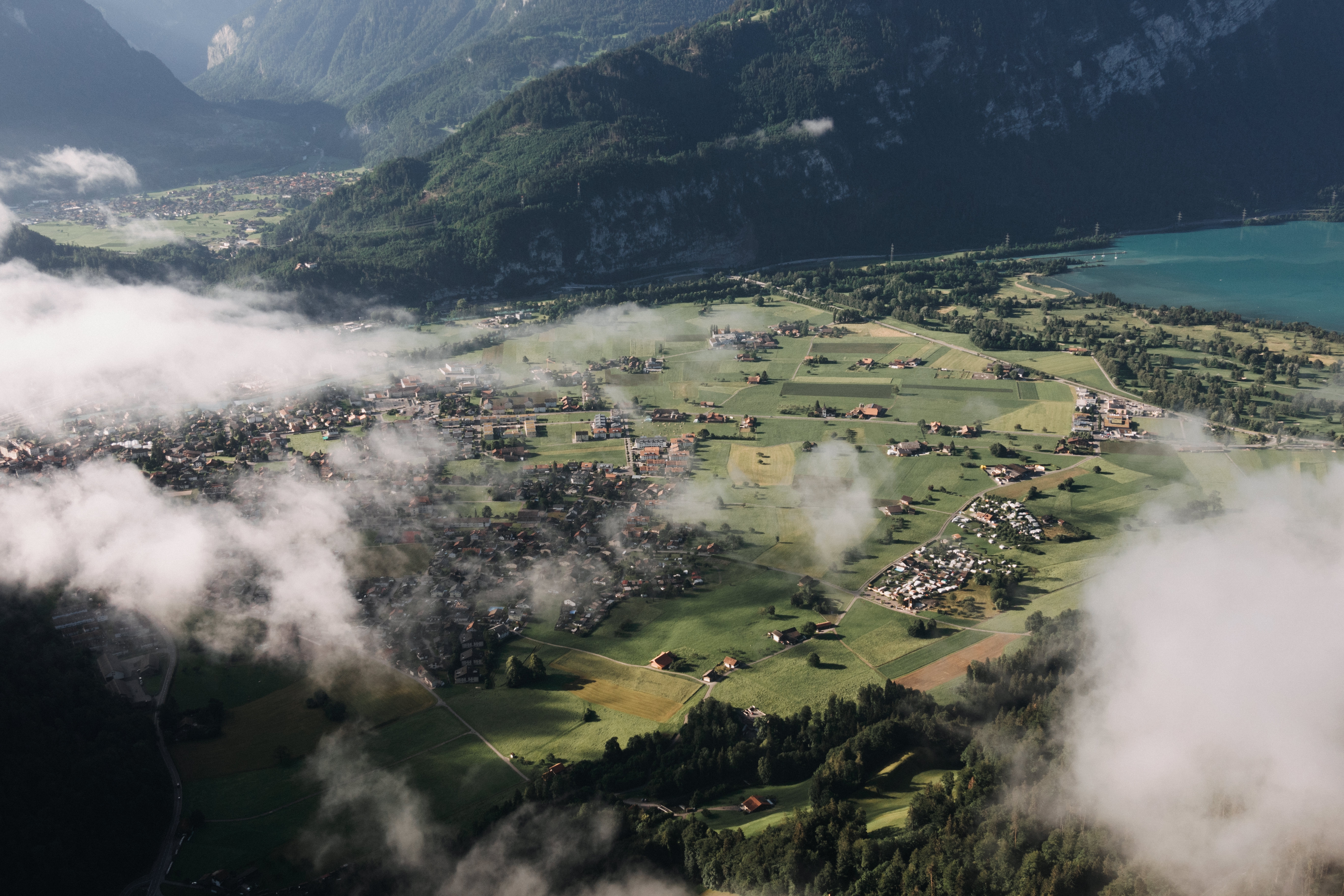 beautiful-aerial-shot-town-surrounded-by-mountains-covered-with-fog.jpg