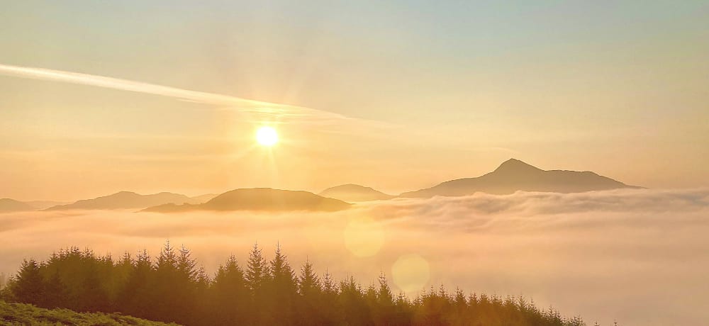 sunrise over a foggy valley