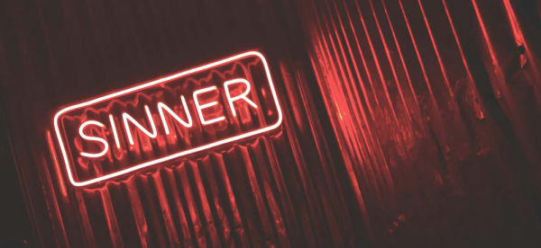 neon sign that reads "sinner"