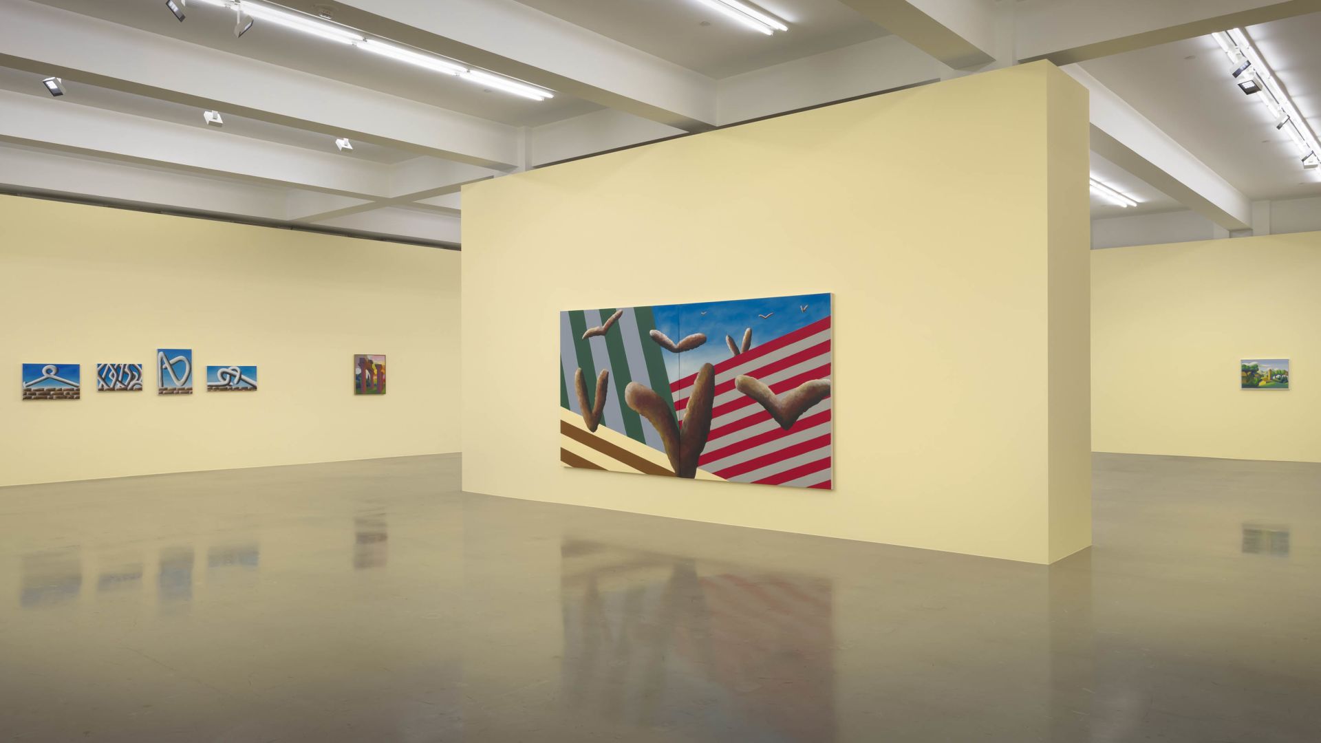 Modern gallery space with white walls displaying various artworks, including a large painting with red and white stripes and organic forms