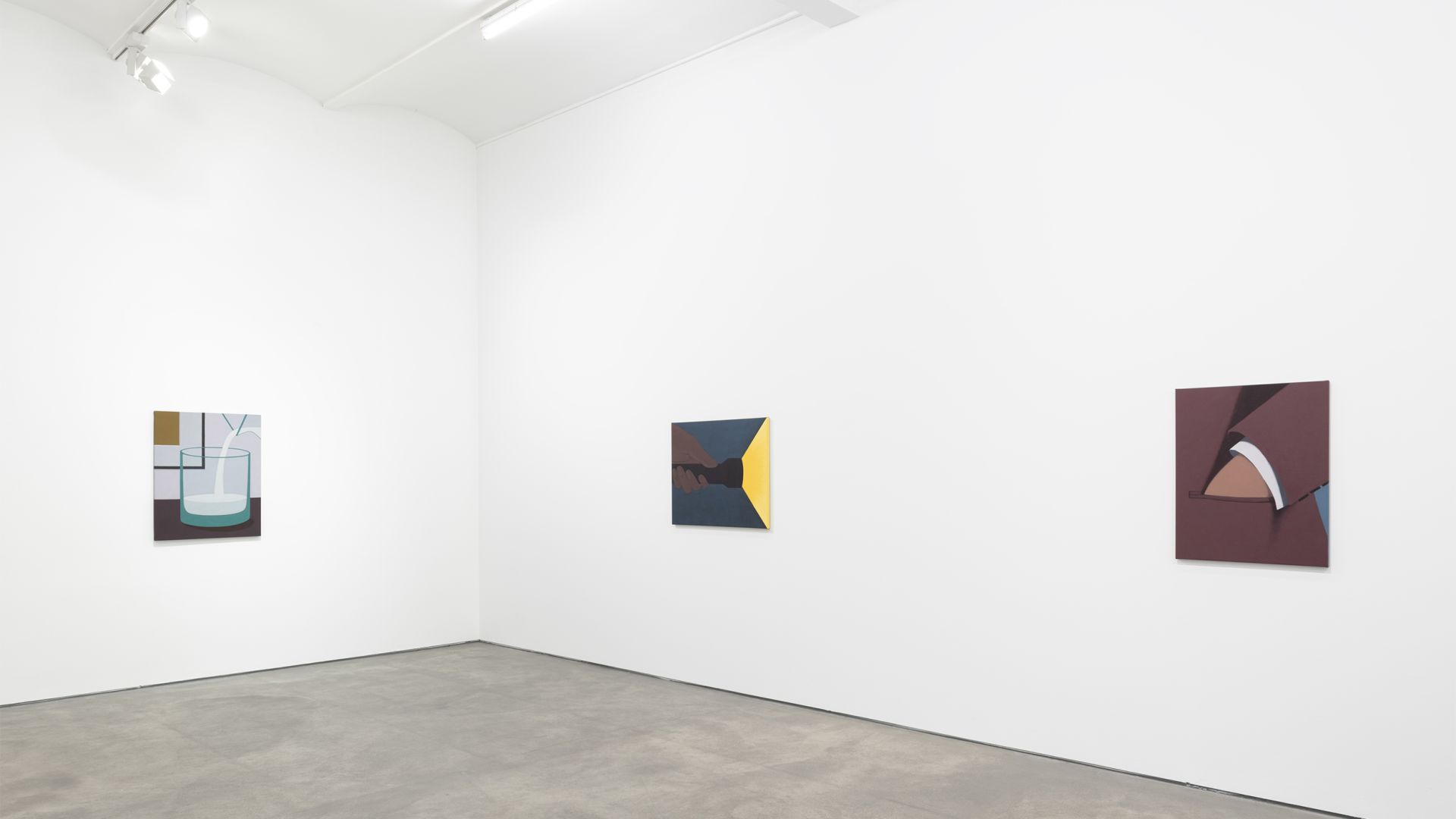 Gallery wall with three abstract paintings: geometric shapes in blues and browns on left, dark and yellow composition in center, burgundy with white curved form on right.