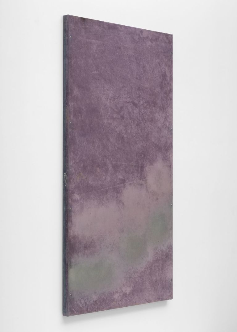 Eight purple abstract paintings arranged in a horizontal line on a white gallery wall, featuring cloudy, atmospheric textures.