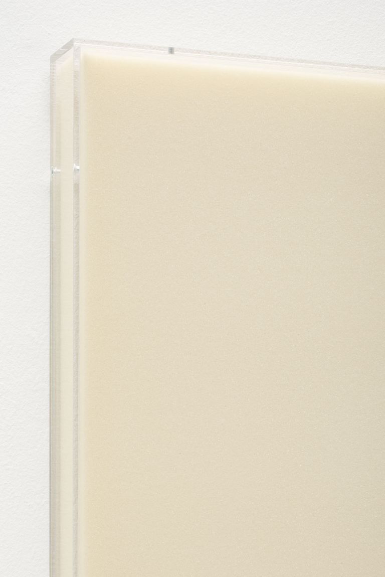 Foam artwork in cream color in acrylic frame, displayed against white background.