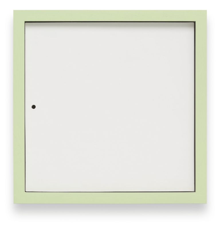 Minimalist white square artwork with green colored borders mounted on white wall. It features a small black hole near the left edge.