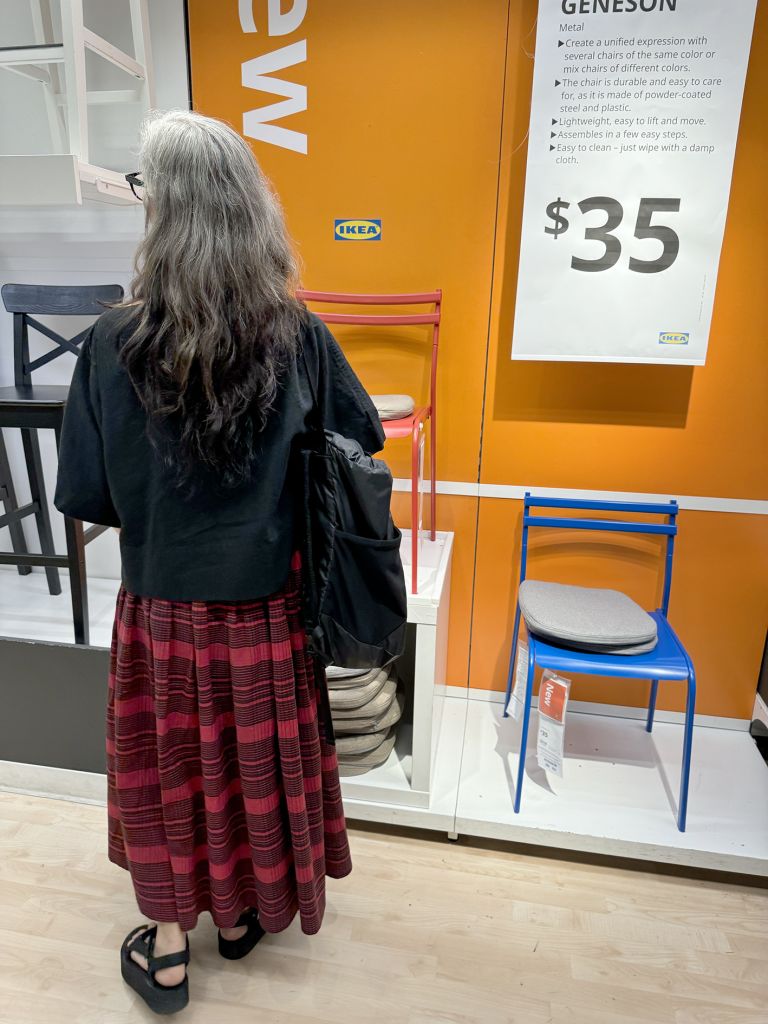 Close-up of framed exhibition panel featuring text about "The Public Performance of the Self" with accompanying photographs of retail spaces.