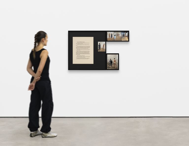 Black-framed display showing text and multiple photographs documenting performance art in various indoor gallery and museum settings.