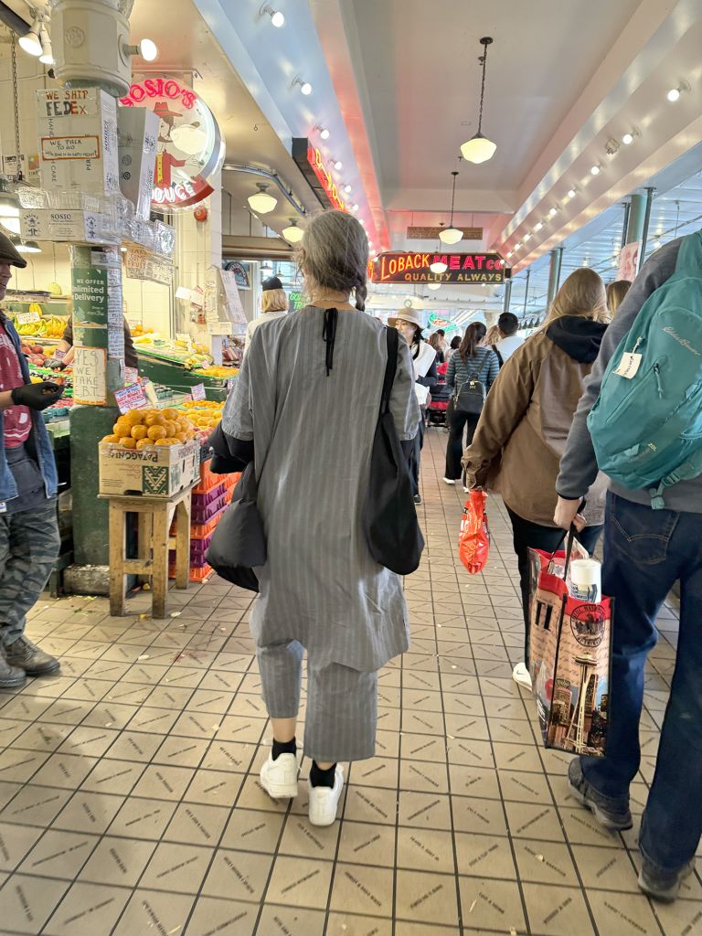 Framed artwork displaying text and photographs documenting street performance, including urban sidewalk and indoor institutional spaces.