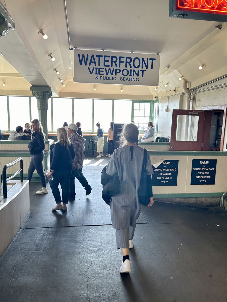 Framed artwork displaying text and photographs documenting street performance, including urban sidewalk and indoor institutional spaces.