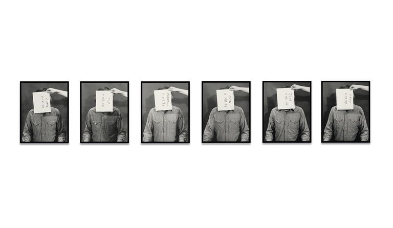 Six sequential black-and-white portraits of person in denim shirt with paper covering face displaying handwritten text