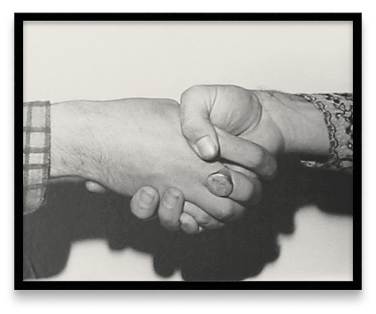 Five framed black and white photographs in a row showing different handshake positions between two people wearing different sleeves