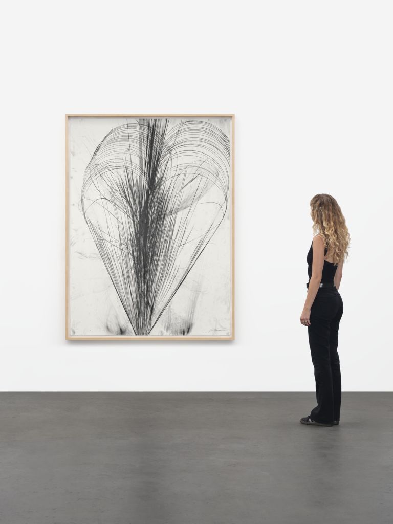 Framed abstract drawing showing heart-shaped black graphite burst with flowing radiating lines