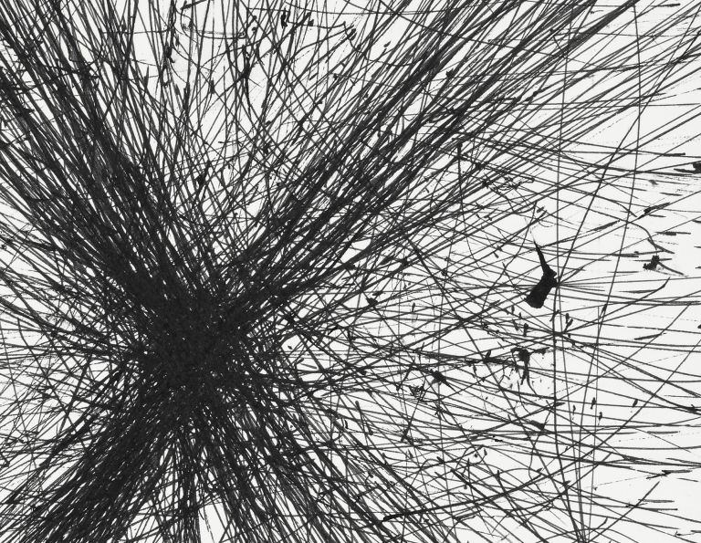 Framed drawing of radiating black graphite lines bursting from central point, matted in white