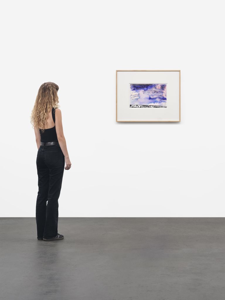 Framed abstract watercolor in blue and pink tones with black textured strip at bottom