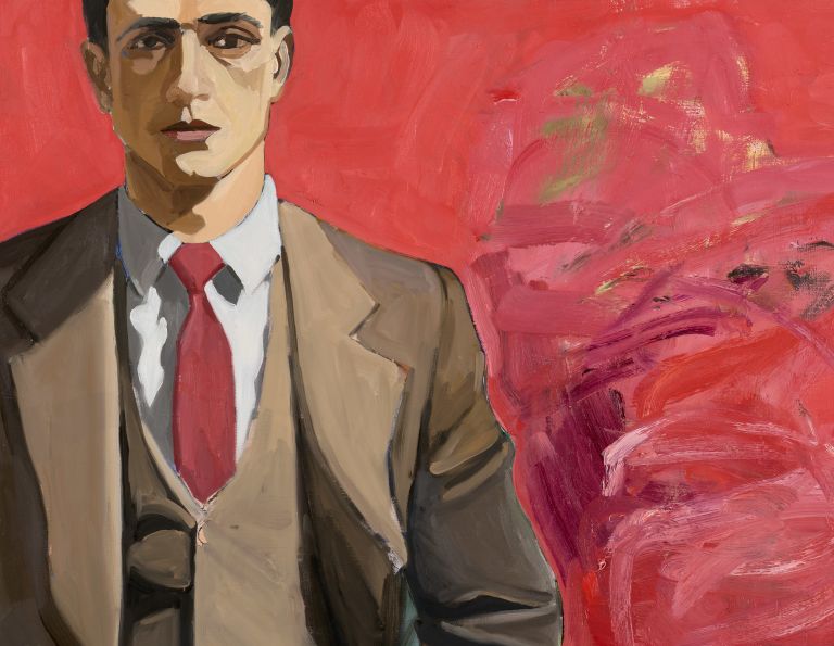 Man in brown suit and red tie stands before a red abstract background, with two women in blue panel.