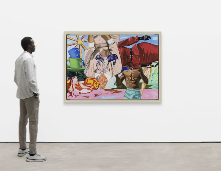 Inverted torso holding irises, shirtless muscular figure, woman in red dress displayed sideways, colorful objects around.