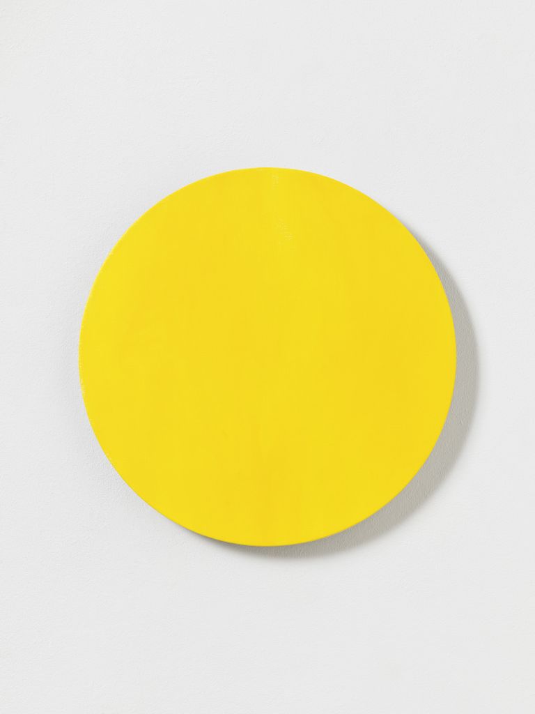 Bright yellow canvas with an asymmetric black leaf-shaped form; small yellow circle beside it.