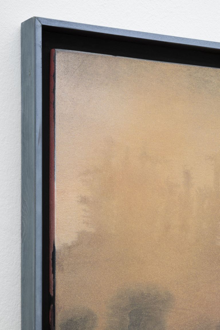 Misty landscape painting: silhouetted treeline over pale blue water beneath warm orange-golden sky.
