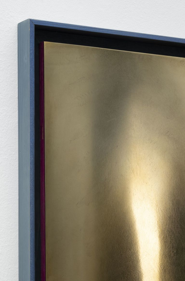 Abstract painting in warm golden tones with two soft amber oval forms glowing against a pale cream surface.