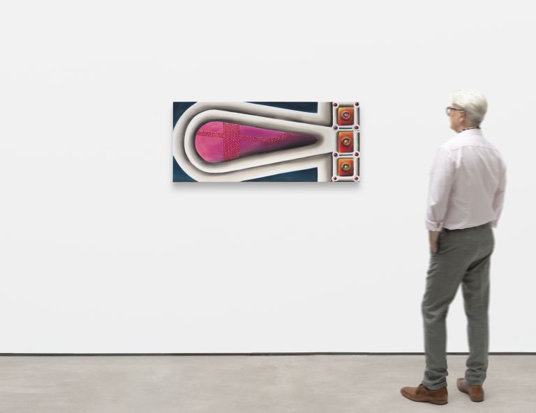 Wide framed painting of a pink teardrop shape with a dotted cross pattern, framed in white, beside orange jeweled squares.