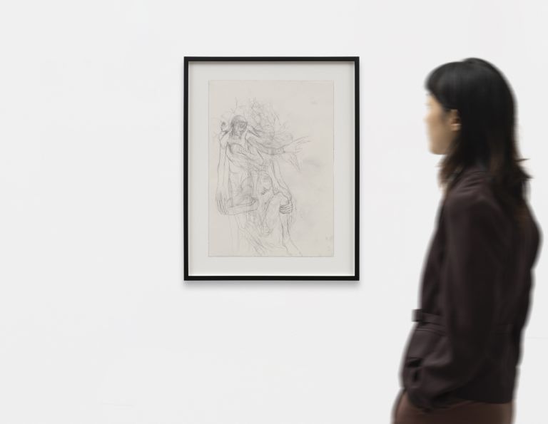 Framed pencil sketch: two intertwined figures, one carrying the other, with expressive tangled lines suggesting movement.