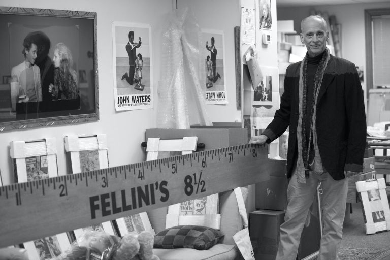 John Waters in his studio with Fellini’s 8 1/2. Courtesy Studio John Waters