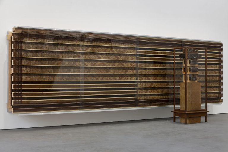 Reinhard Mucha
Die Deutsche Frage / Dornap, F&uuml;r Philip Nelson, 2007
The German Question / Dornap, For Philip Nelson
2-part work ensemble
Free-standing sculpture
Die Deutsche Frage, 2007
Solid wood, float glass (display case), hardboard and oil paint print on bituminized felt base (flooring, found material) on blockboard (pedestal), 4 footstools wood (found objects), 4 cardboard suitcases leatherboard, metal (found objects)
182.6 x 77 x 52 cm
72 x 30 1/4 x 20 1/2 inches
Wall-mounted sculpture
Dornap, F&uuml;r Philip Nelson, 2007
Aluminum profiles, alkyd enamel painted on reverse of float glass, oil paint print on bituminized felt base (flooring, found material), hardboard, blockboard
177.8 x 599.7 x 53.7 cm
70 x 236 x 21 1/8 inches
&copy; muchaArchive