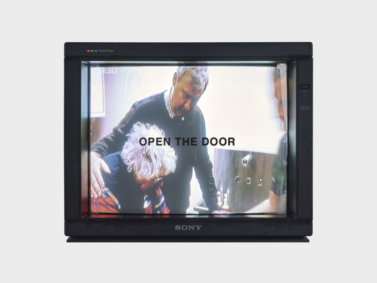 Gretchen Bender
TV Text & Image (OPEN THE DOOR), c. 1988
Live television broadcast on a monitor, vinyl lettering
Dimensions variable
Edition of 3 + 1 AP
