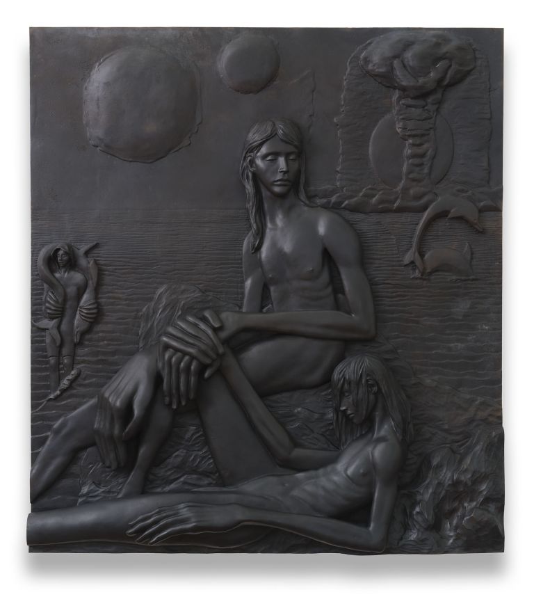 Large dark relief sculpture depicting nude figures in a dramatic scene with celestial elements like moons and clouds in the composition.