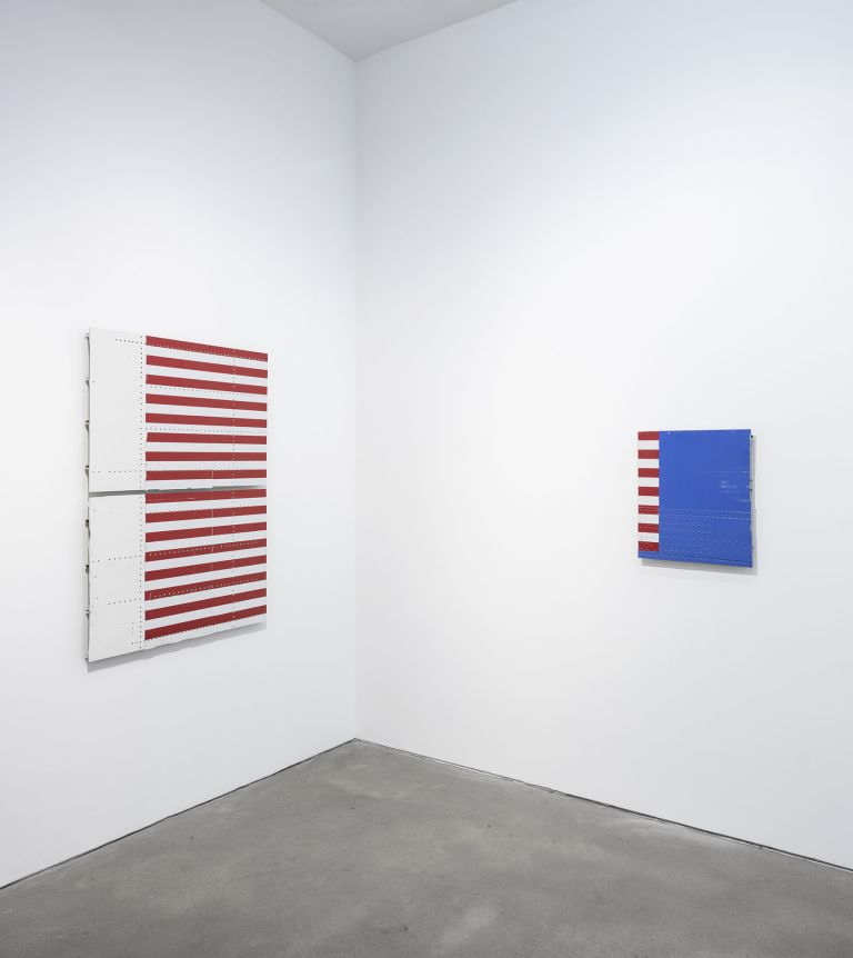Abstract artwork with red and white horizontal stripes covering most of the surface, with white space on left side and visible perforation dots