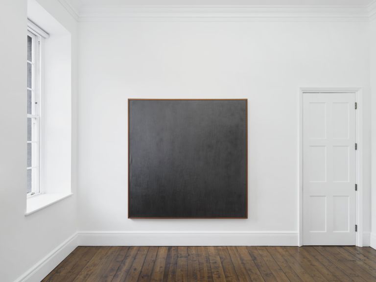 Large square canvas painted in dark gray with subtle texture variations, presented in wooden frame