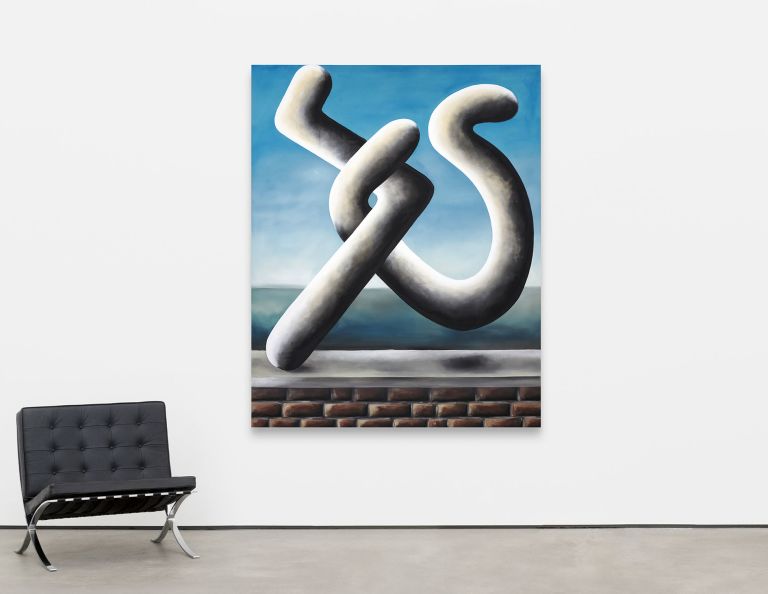 Close-up of white sculptural form with intertwining curved elements against blue sky, positioned above a brick foundation