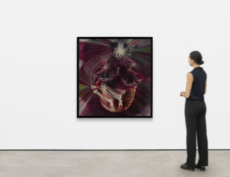 Abstract digital artwork featuring a distorted human skeleton figure surrounded by radiating magenta, red, and green light patterns.