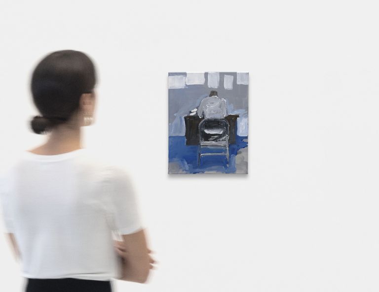 Painting of a figure from behind sitting in a black chair against blue and gray tones with white rectangular shapes above.