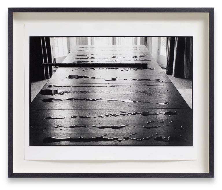 Six identical framed photographs in a horizontal row showing perspective view down a wooden pier or boardwalk in black and white