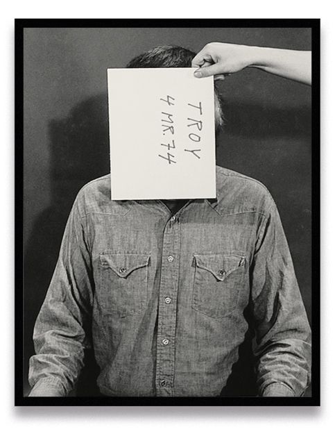 Six sequential black-and-white portraits of person in denim shirt with paper covering face displaying handwritten text