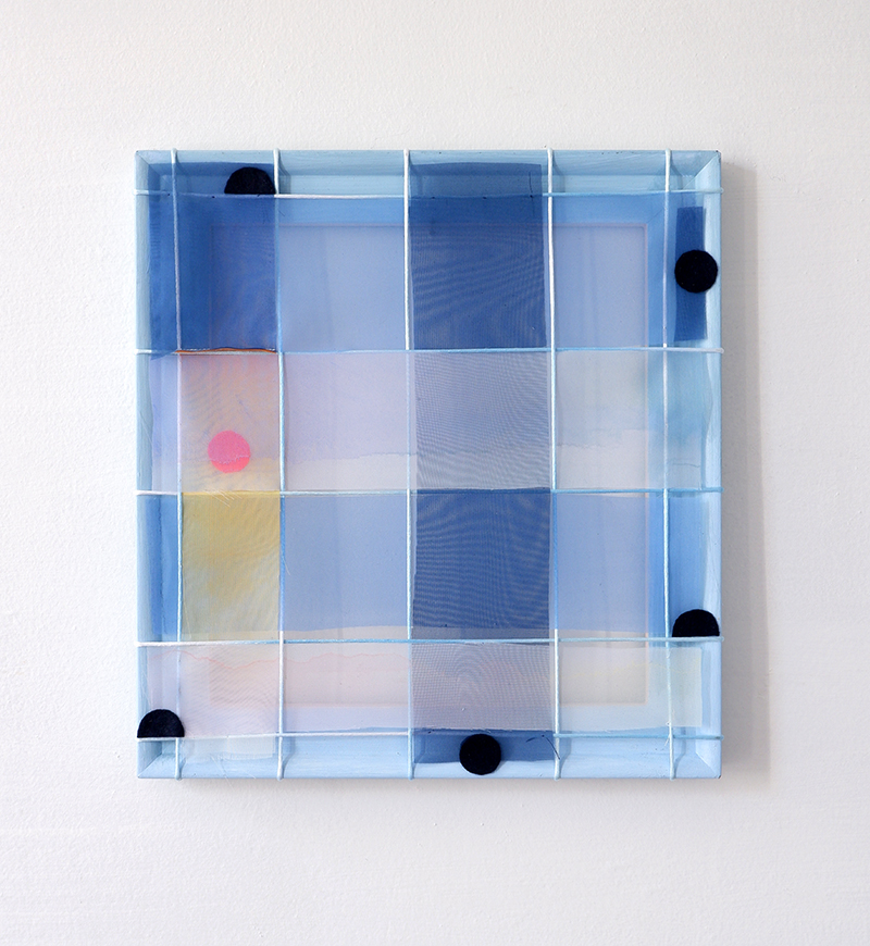 A square abstract artwork with a translucent grid woven and stretched over a frame. The composition is dominated by shades of blue, with sections of soft pink and yellow. A bright pink circle appears in the left center, while black circular shapes are placed around the edges.