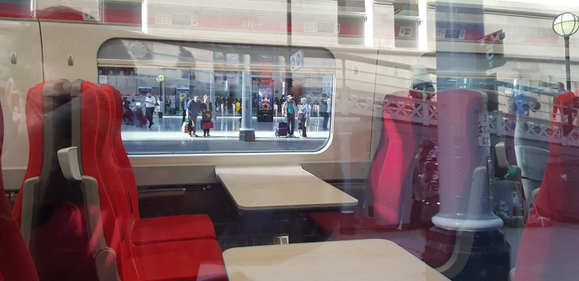 A peek through a window at a Standard Class table seat